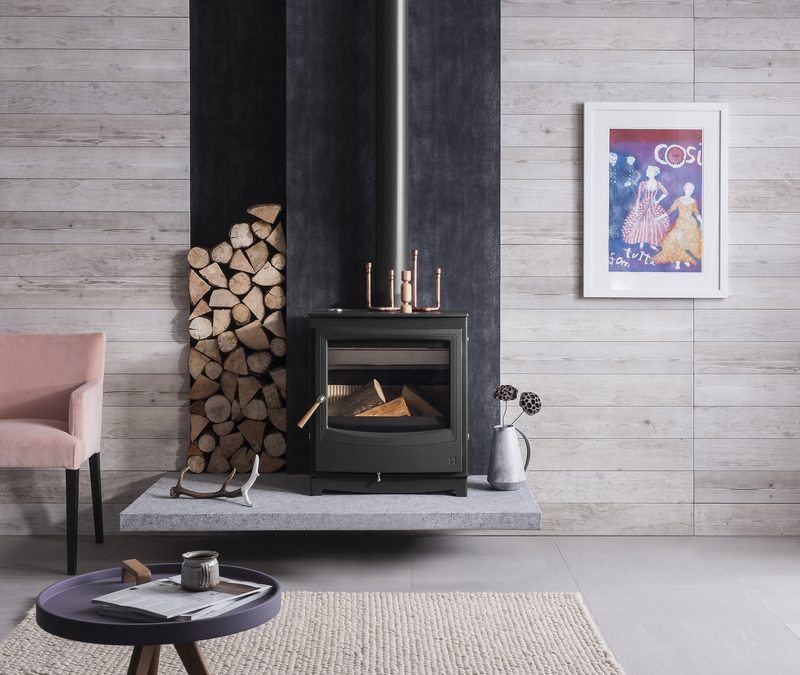 Arada Farringdon Catalyst Eco wood burning stove in a modern living room with log store
