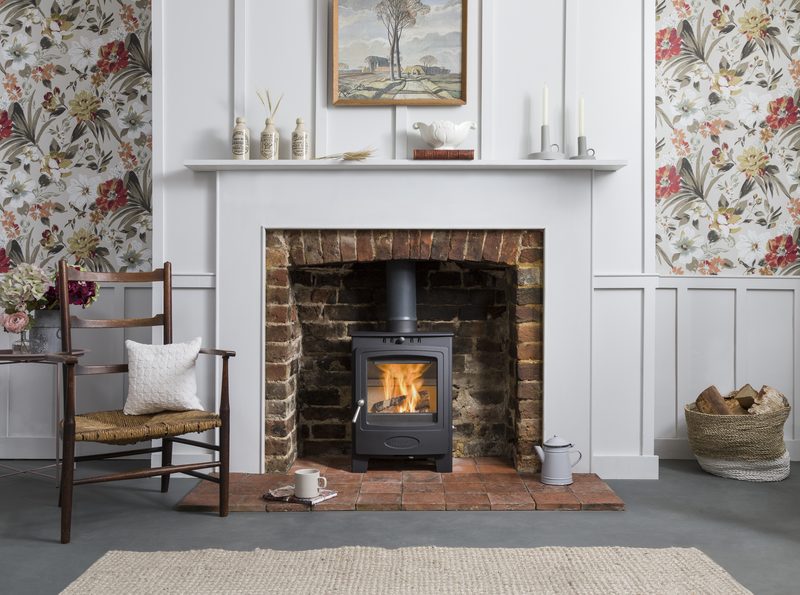 Arada Solution 5 multi-fuel stove in a traditional brick fireplace with mantelpiece